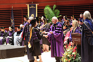 Dean Roger Dennis congratulates new grad at commencement 2016